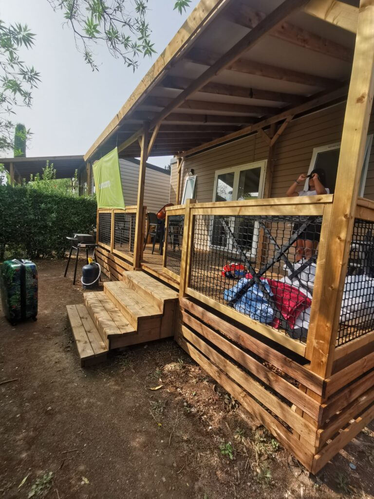 Eurocamp French Riviera mobile home with covered wooden decking and outdoor seating.