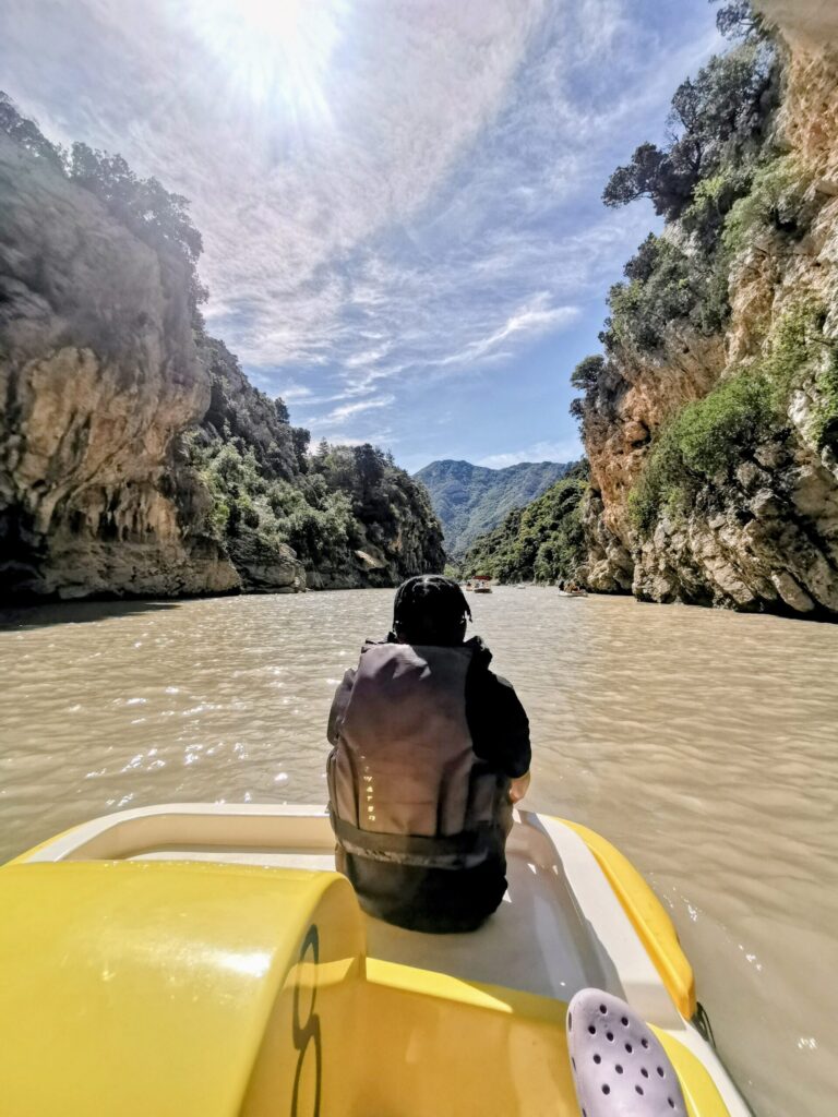 Kayaking through Gorge du Verdon with steep cliffs rising on both sides. 
