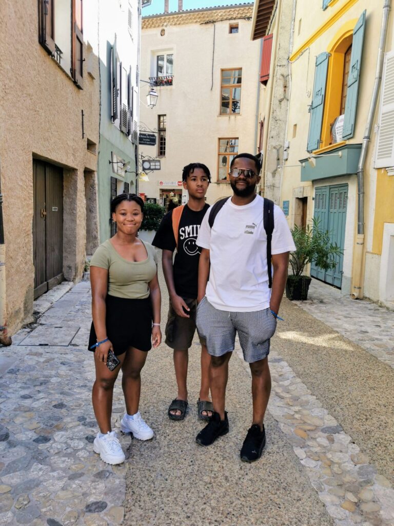 Family walking through Sainte-Croix-du-Verdon village with stone streets and scenic views