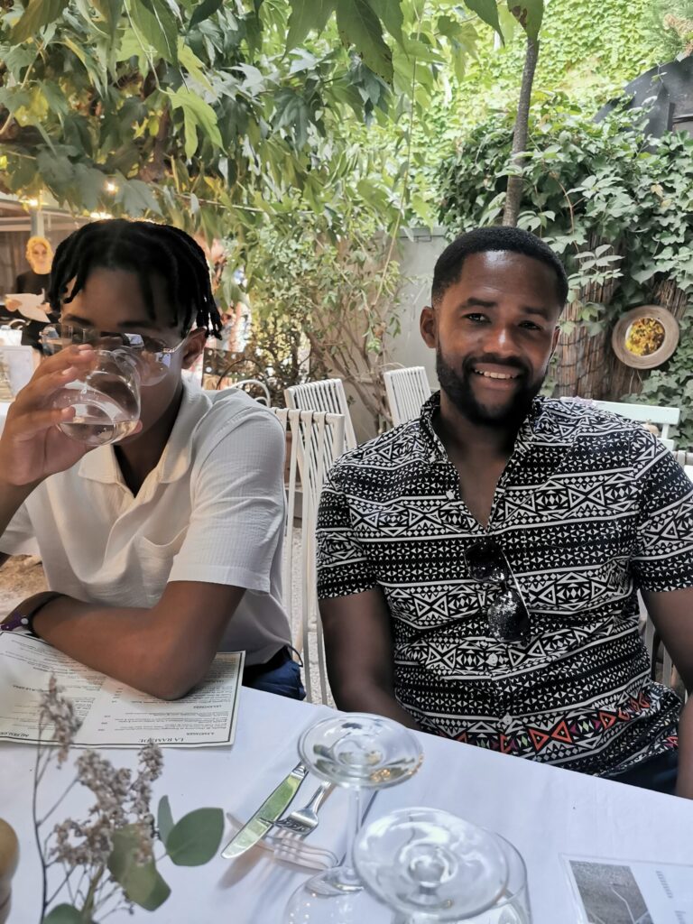 Family sharing a relaxed dinner together at La Ramade restaurant in Saint Tropez on the French Riviera.