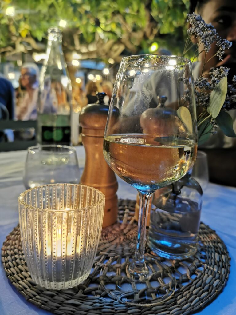 Outdoor dining table with candlelight and wine glasses at La Ramade restaurant in St Tropez on the French Riviera.