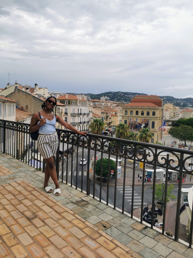 Woman looking over Cannes rooftops from the Le Suquet viewpoint on the French Riviera