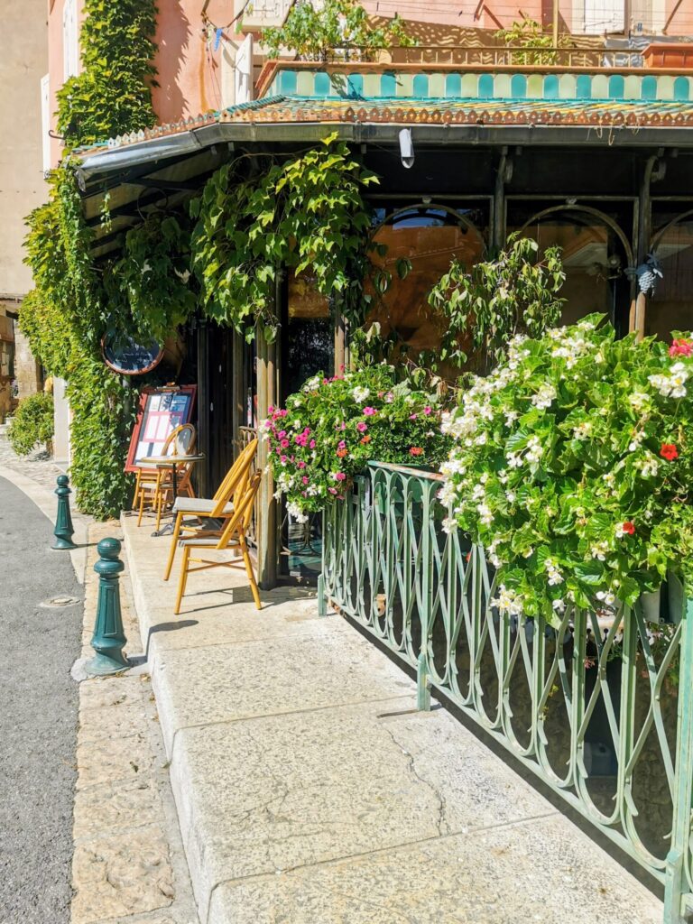Charming stone building in Sainte-Croix-du-Verdon with greenery and flowers
