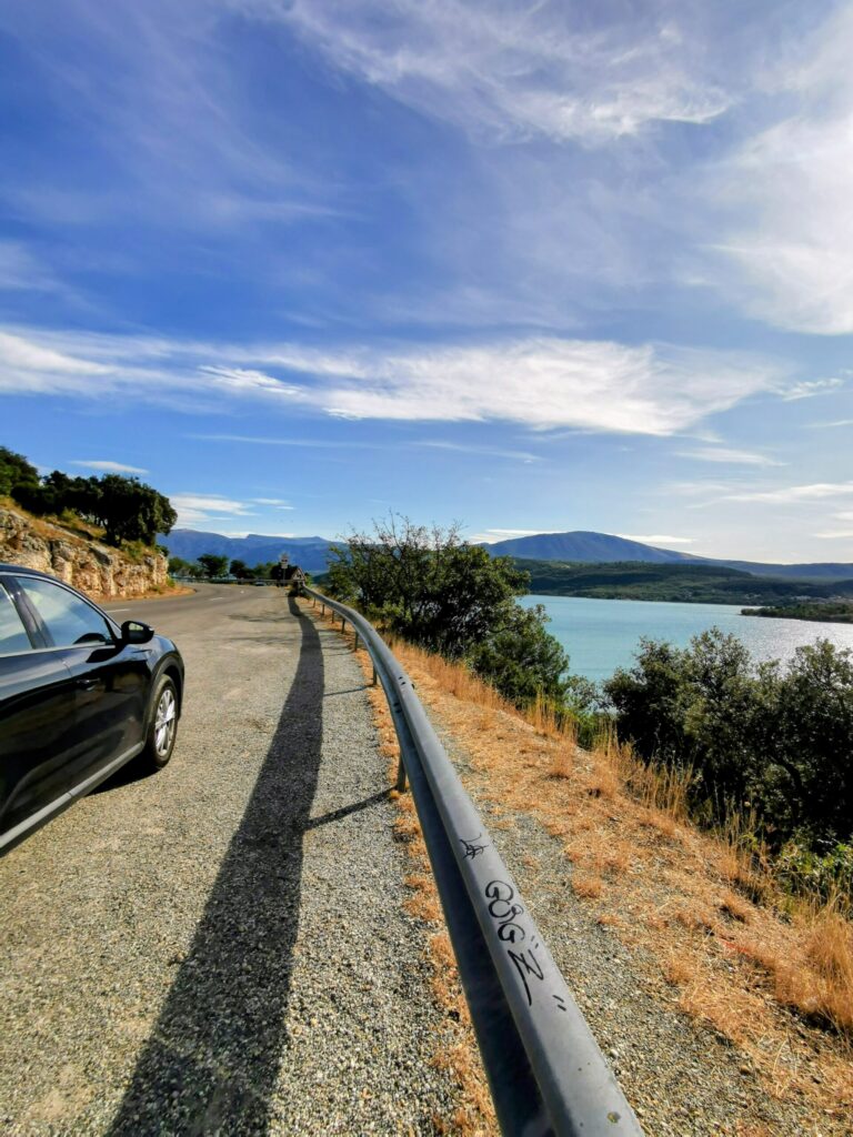 Winding mountain road through the Gorge du Verdon with steep cliffs and scenic views.
