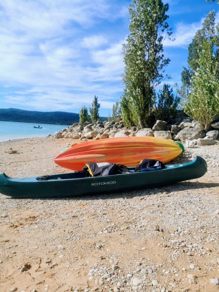 Colourful kayaks lined up on the shore at Lac Sainte-Croix in Gorge du Verdon