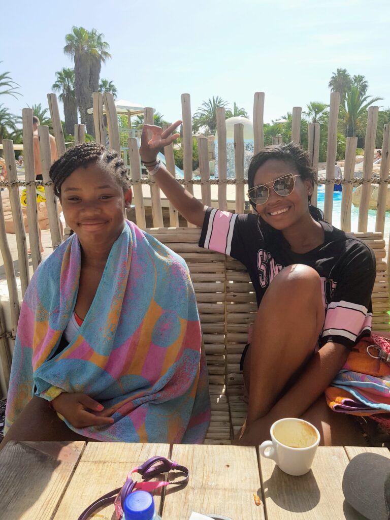 Mum and daughter relaxing by the pool at a Eurocamp campsite in the South of France.
