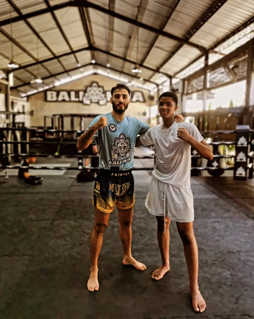 Young man with his Muay Thai trainer after a training session at Bali MMA in Seminyak.