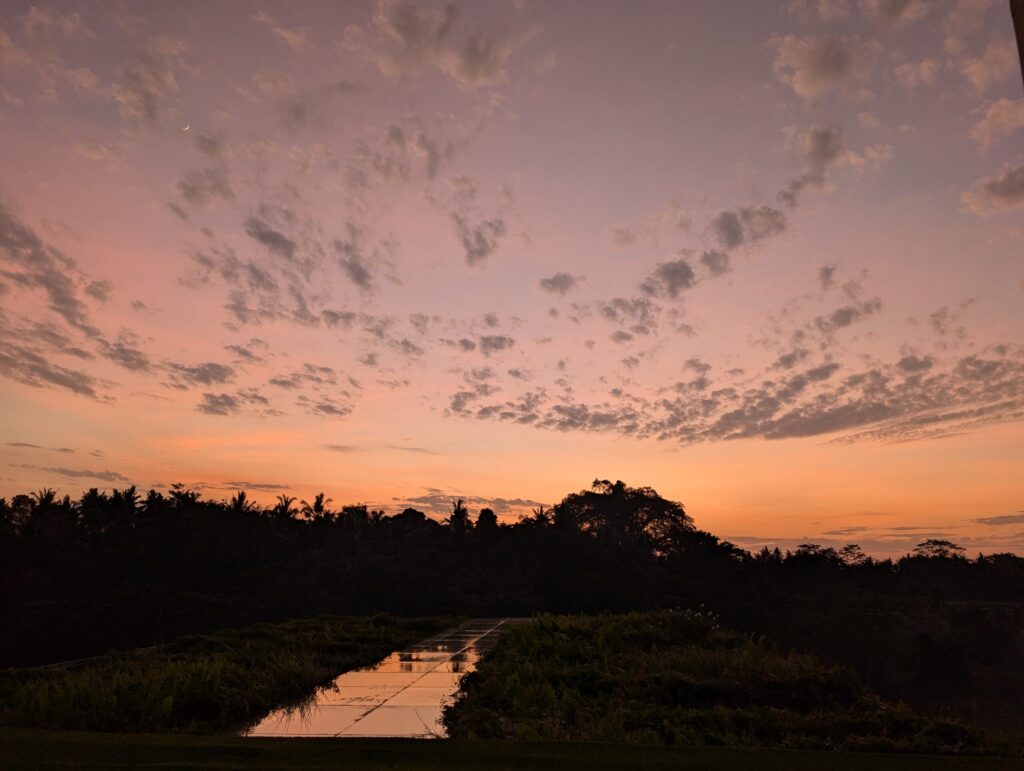 Orange sunrise over the tropical landscape in Ubud, Bali.
